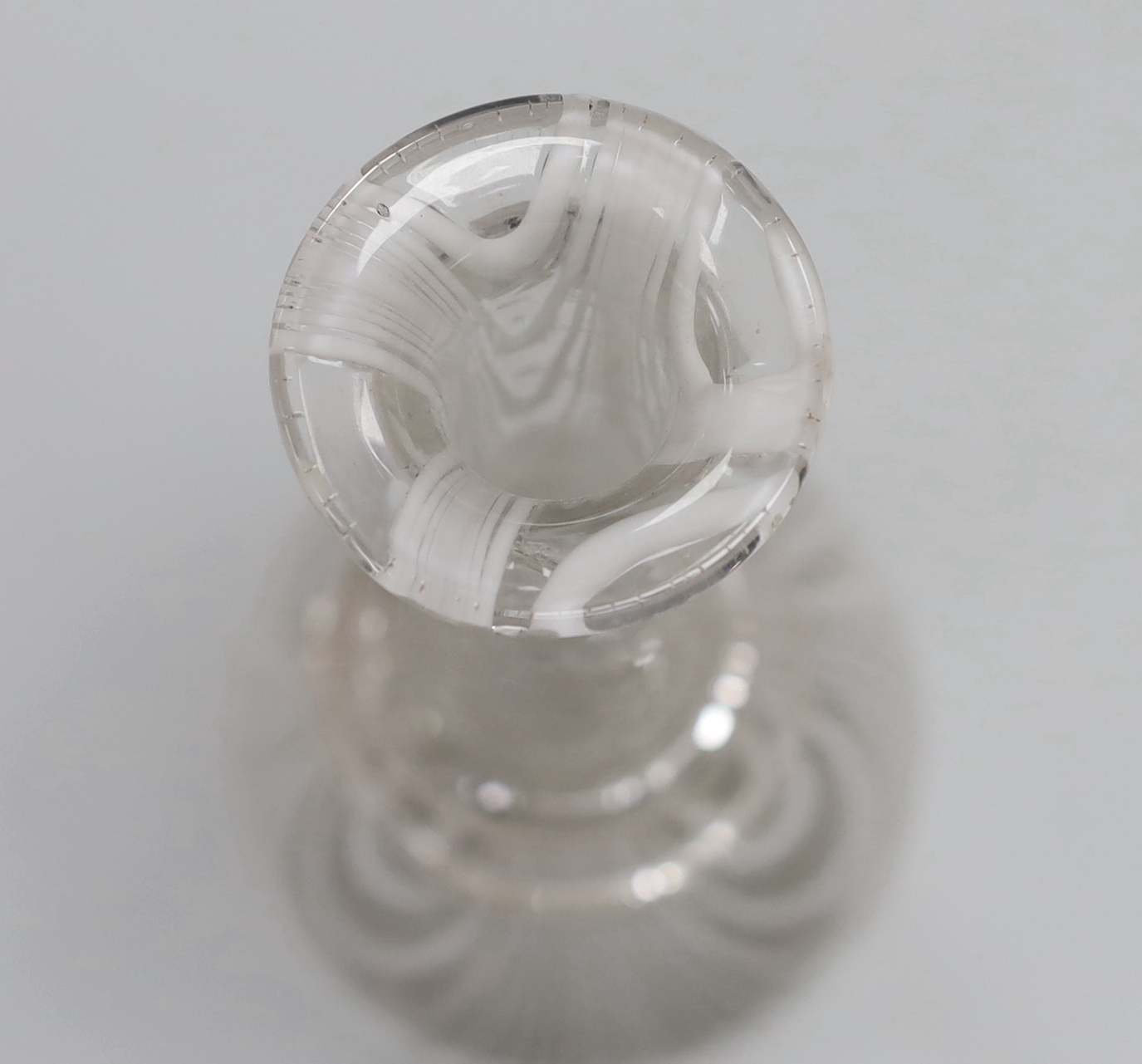 A 19th century Nailsea bottle vase, c1840-50, of long necked form with white combed decoration, three applied neck rings and rough pontil, 33cm high